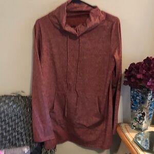 Great pullover top with string ties and front pouch style pockets.